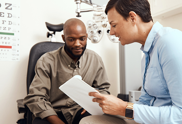 Eye doctor speaking with patient