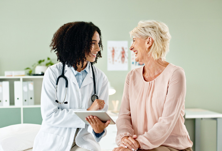 Healthcare professional consulting patient with tablet